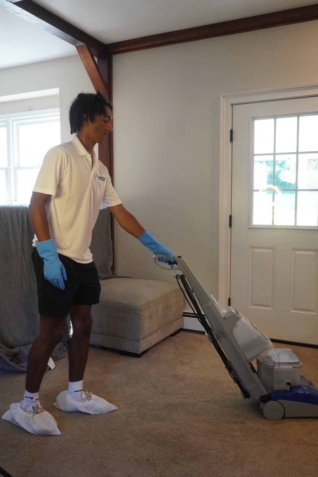 Clean Ops Solutions team member deep cleaning carpets in a Doylestown, PA home