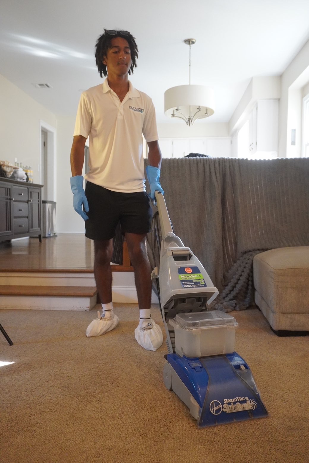 Clean Ops Solutions team member deep cleaning carpets