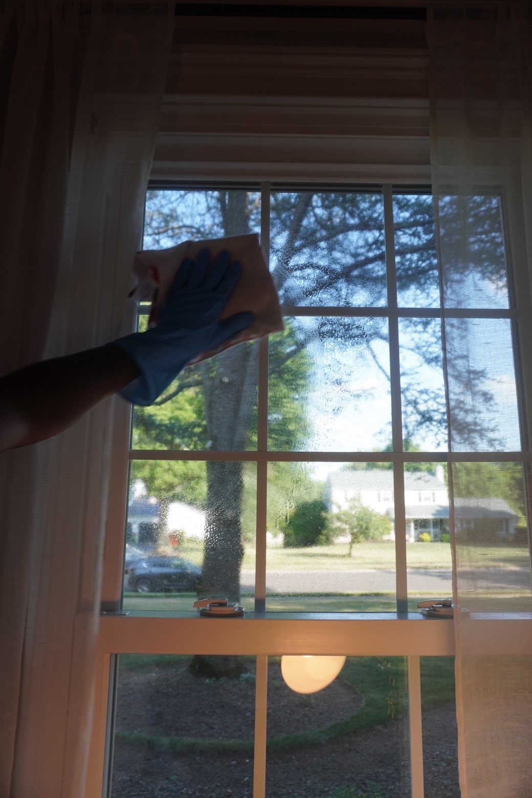 Clean Ops Solutions team member cleaning a window