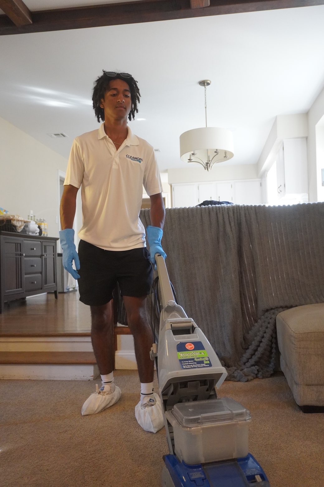 Clean Ops Solutions team member cleaning a living room during a move-out cleaning in Doylestown, PA